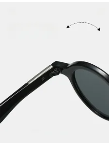 Macro detail of the durable metal hinge on vintage oval sunglasses with a black frame