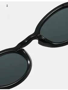 Close-up of comfortable integrated nose pads on black oval sunglasses for long-term wear