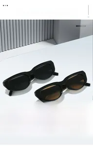 Detail view of vintage chunky black cat-eye sunglasses with gradient lenses on white display