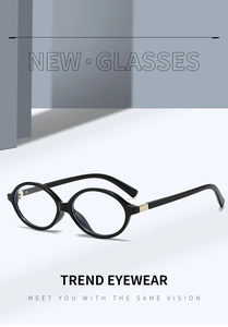 Detailed close-up of retro black oval frames with signature gold square hinge accents