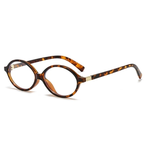 Stylish oval tortoiseshell frames with golden metal hinge details and clear lenses