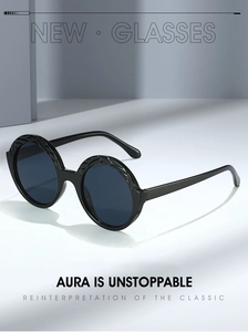 Detail of round sunglasses featuring textured leaf patterns on the black frame