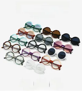 Flat lay of retro round sunglasses in 13 diverse colors including leopard and gradient hues