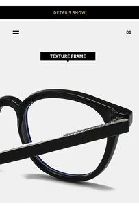 Detail of black oval eyeglass frame hinge with silver metal decorative accents