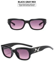 Detail of square black sunglasses with gray-red gradient lenses and silver metal temple inlay