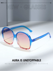 Close-up of oversized sunglasses with gradient frame and gold metal temple accents