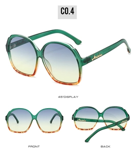 Detail view of oval emerald green sunglasses with tortoise pattern and gradient lenses