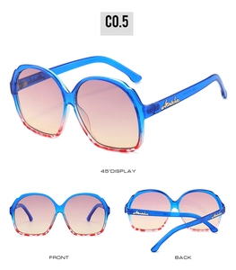 Detail view of oval sunglasses with blue frames, rhinestone logo and leopard print trim