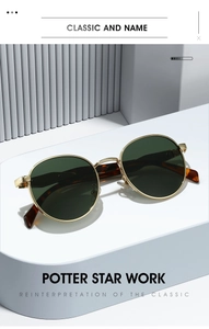 Detail view of retro gold metal sunglasses with dark green lenses on a white pedestal