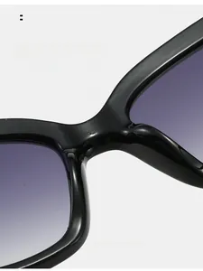 Detail of integrated nose pads on black cat-eye sunglasses with purple gradient lenses