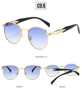 Detail view of oval gold metal sunglasses with blue gradient lenses and adjustable nose pads
