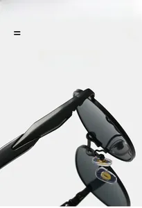 Detailed macro view of black metal hinges and silicone nose pads on oval sunglasses