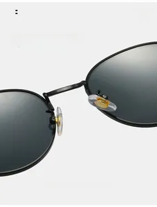 Detail of adjustable silicone nose pads on retro oval metal frame sunglasses