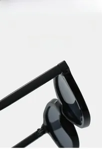 Detail of super elastic hinge and glossy black frame on retro oval sunglasses