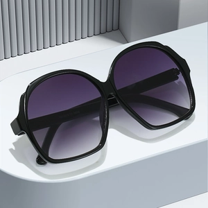 Oversized oval sunglasses with black frames and purple gradient lenses on a white display