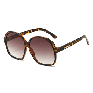 Tortoiseshell oval oversized sunglasses with brown gradient lenses and gold side letter logo