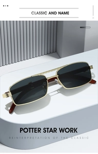 Detailed view of rectangle gold metal sunglasses with textured temples and dark lenses