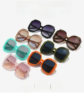 Detail showing oversized square sunglasses with unique double-line hollow frame design