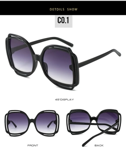 Detail view of butterfly sunglasses with black hollow frame and purple gradient lenses
