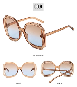 Detail view of square sunglasses with hollow frames and gradient brown-blue lenses