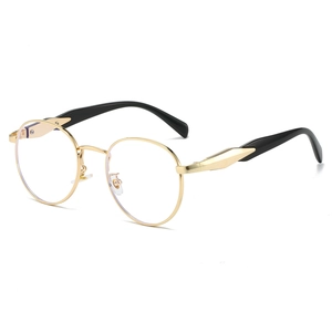 Vintage oval metal sunglasses with gold frames and black ergonomic temples in side view