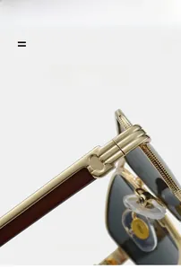 Detail of premium gold metal hinge and reddish-brown wood grain temple on rectangle sunglasses