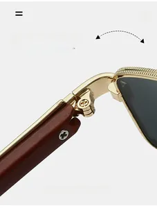 Detail of durable gold metal hinge and dark brown wood texture temple on sunglasses