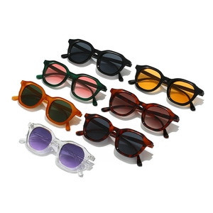 Set of seven retro oval sunglasses in various colors on a clean white background