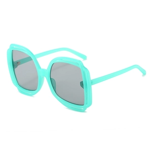 Oversized square sunglasses with translucent mint green frames and dark grey lenses