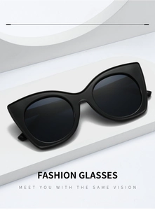 Fashion cat eye sunglasses with black frames and dark lenses on a geometric display