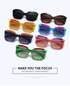 Flat lay of retro cat eye sunglasses in seven vibrant gradient color combinations