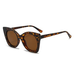 Retro cat-eye sunglasses with tortoise shell frame and brown lenses on white background