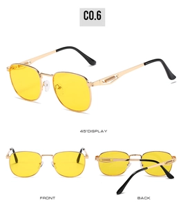 Detail view of gold metal square sunglasses with yellow lenses and spring hinge design