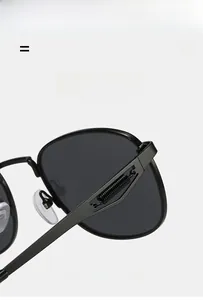 Macro detail of the durable black metal spring hinge on retro aviator sunglasses