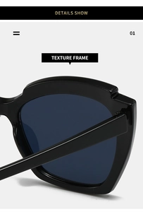 Detail shot of vintage cat-eye sunglasses with textured black frames and blue lenses