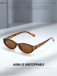 Detail of tortoise shell sunglasses frame showing a metallic silver logo on the temple