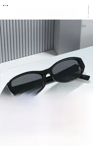 Classic black oval frame retro sunglasses displayed on a minimalist geometric white pedestal