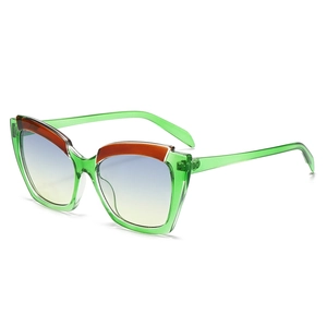 Retro cat-eye sunglasses with green transparent frames and orange decorative accents