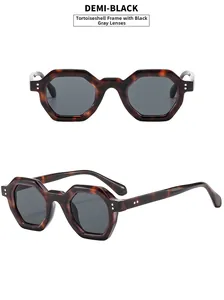 Detail view of tortoiseshell geometric sunglasses with dark grey lenses and metal accents