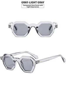Detail view of hexagonal transparent grey sunglasses with metallic rivets and light grey lenses