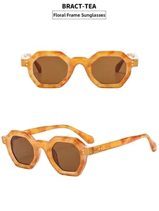 Close-up of tortoise shell polygonal sunglasses with deep tea lenses on white background