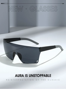 Close-up of shield sunglasses with grey lenses and wide black temples in a modern studio