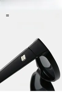 Detail shot of black sunglasses featuring a silver geometric logo on the temple
