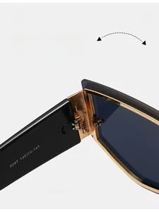 Macro shot of reinforced metal hinges on oversized rimless sunglasses with gold accents
