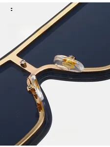 Macro shot of comfortable clear nose pads with gold logo on oversized sunglasses