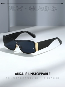 Detail of black oversized hip-hop sunglasses with golden metal hinge on white steps