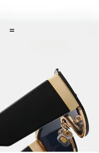 Detailed close-up of premium metal hinges and gold accents on black oversized sunglasses
