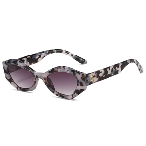 Lunettes de soleil œil-de-chat polygonales avec monture marbrée et verres dégradés violets