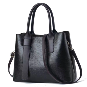 Classic dark brown leather tote bag with top handles and adjustable shoulder strap