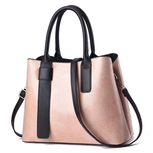 Pink metallic leather handbag for women with brown handles and adjustable strap
